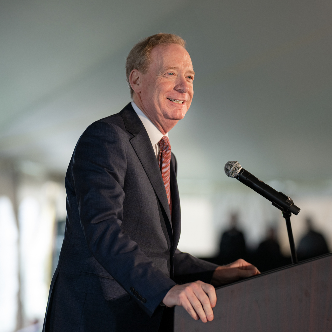Brad Smith addresses the crowd at a podium