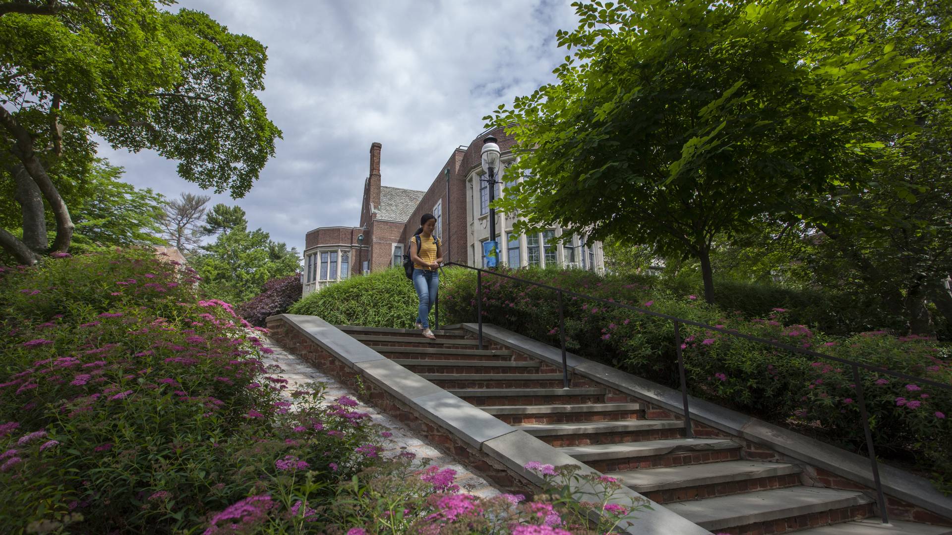 Student walking down stairs by McCosh