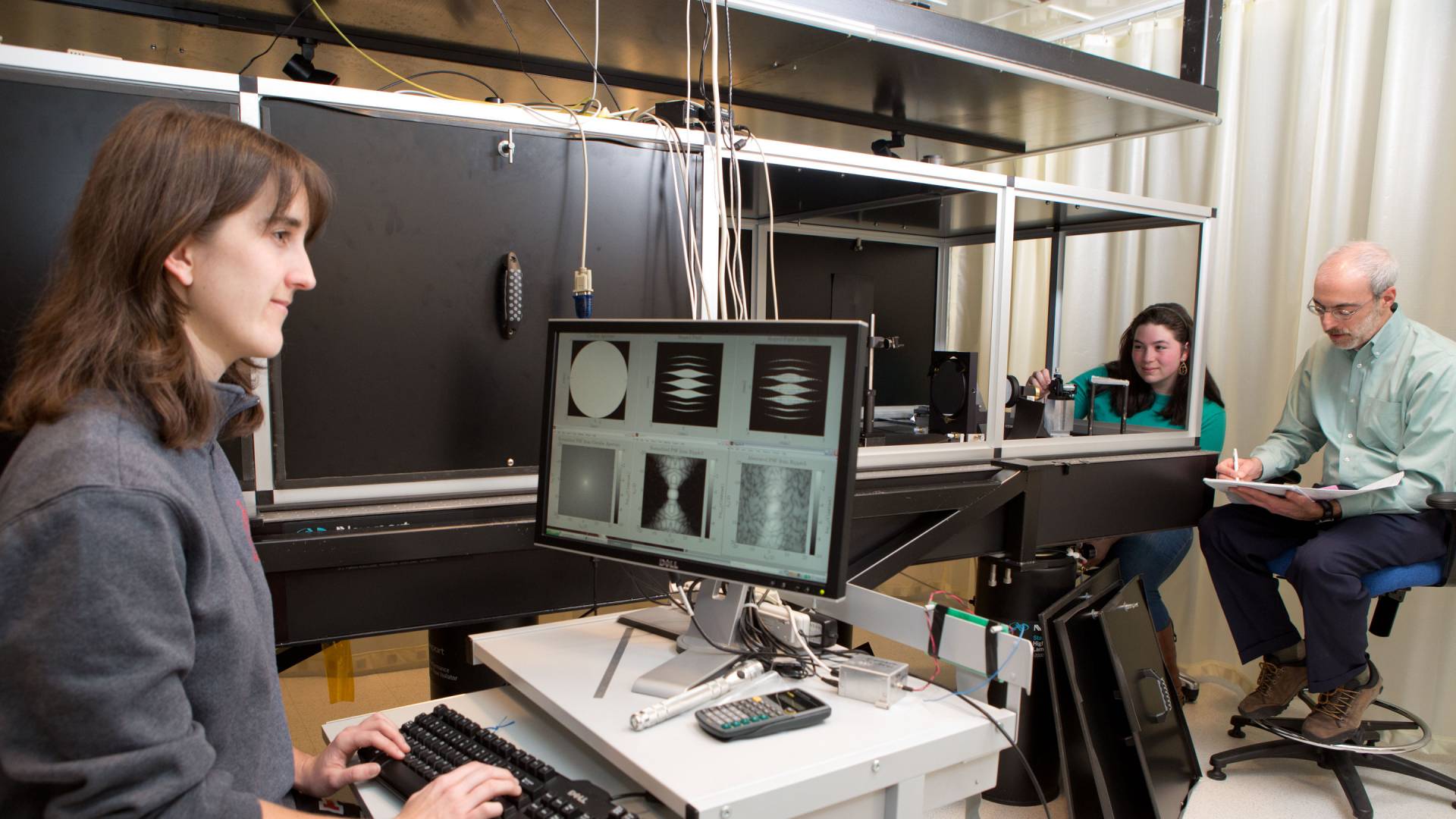 Student looks at research image on computer.