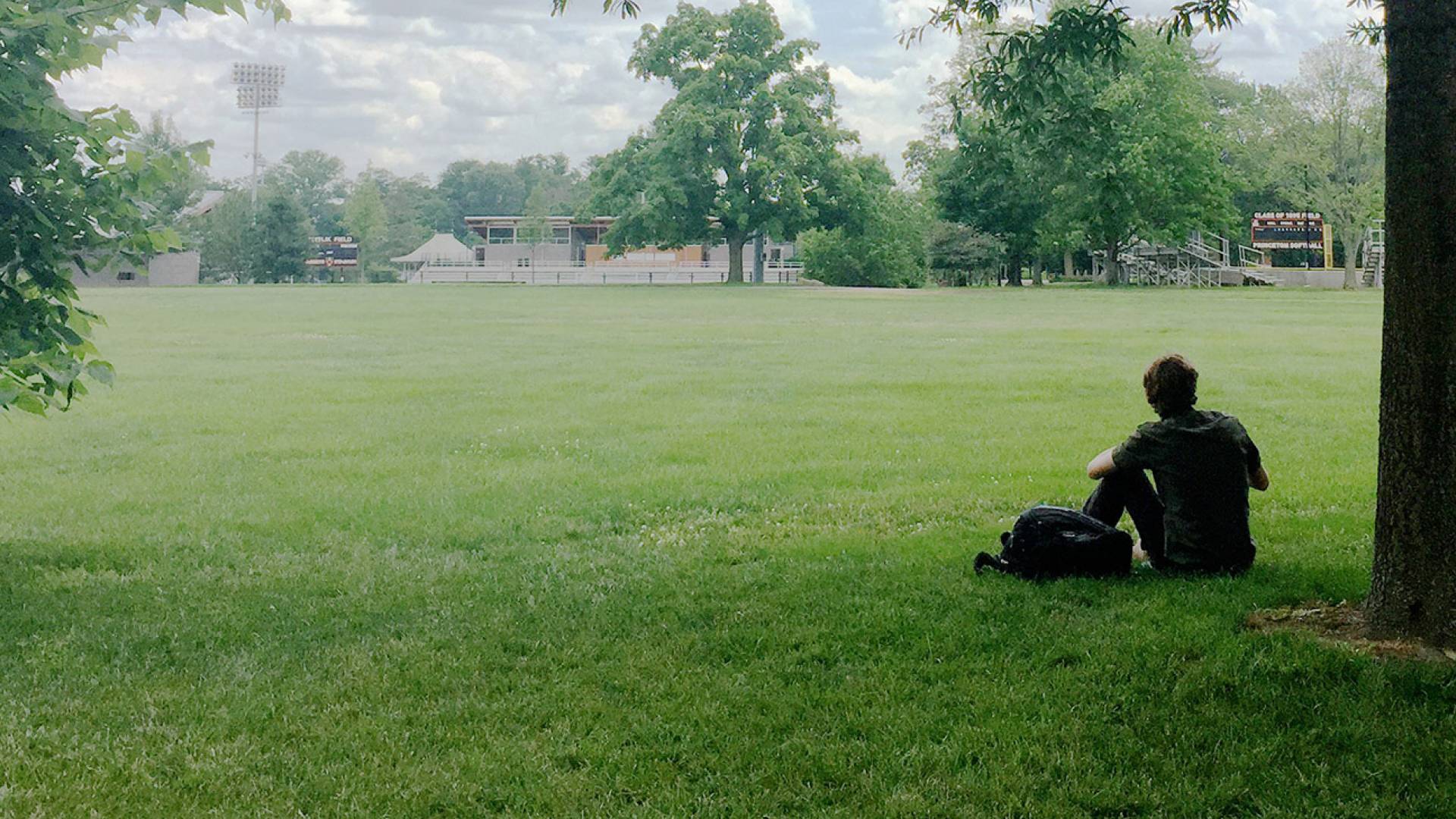 Student with backpack in Poe Field