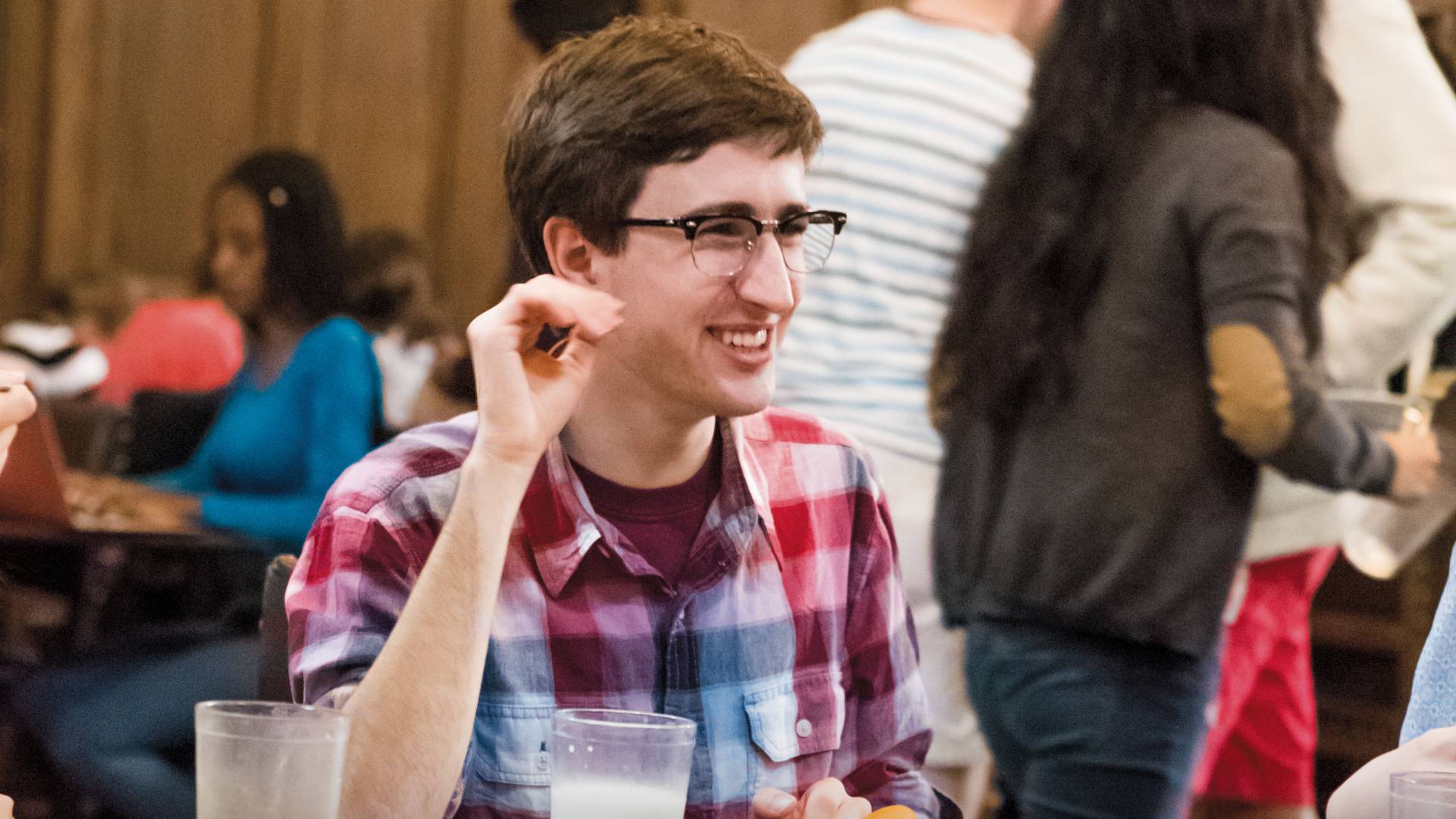 Colin Lualdi eating with friends in dining hall