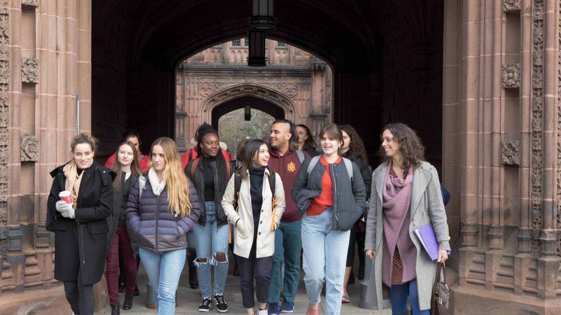 Students and professor walking across campus