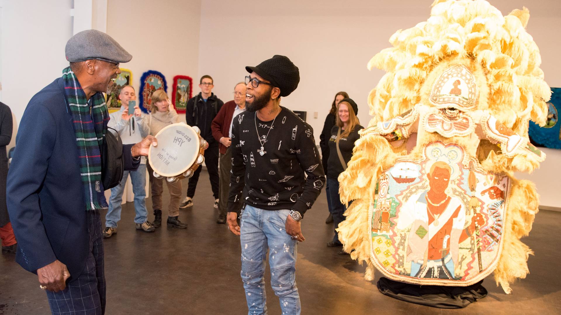 Big Chief Darryl Montana and Big Chief Demond Melancon dancing in front of ceremonial suit