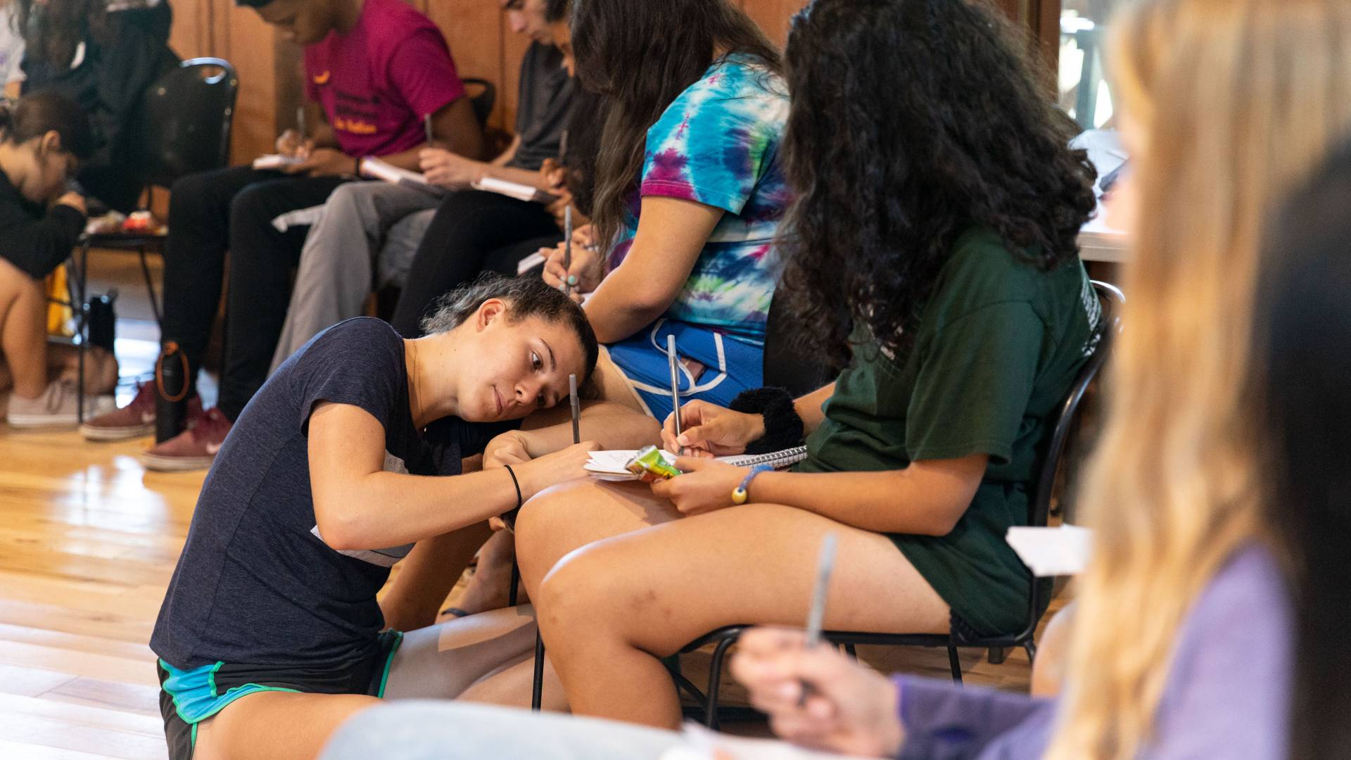 Madeleine Quackenbush writing in notebook