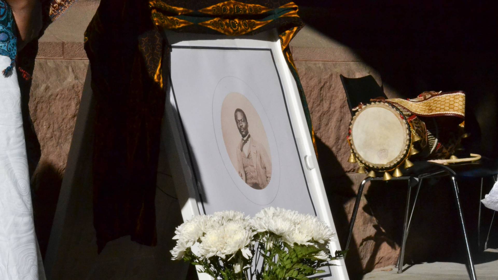 Framed photo of Johnson with flowers and drums nearby