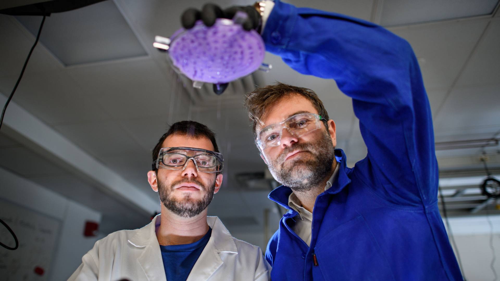 Pierre-Thomas Brun holds a sample up on the right while Joel Marthelot looks on to the left of him