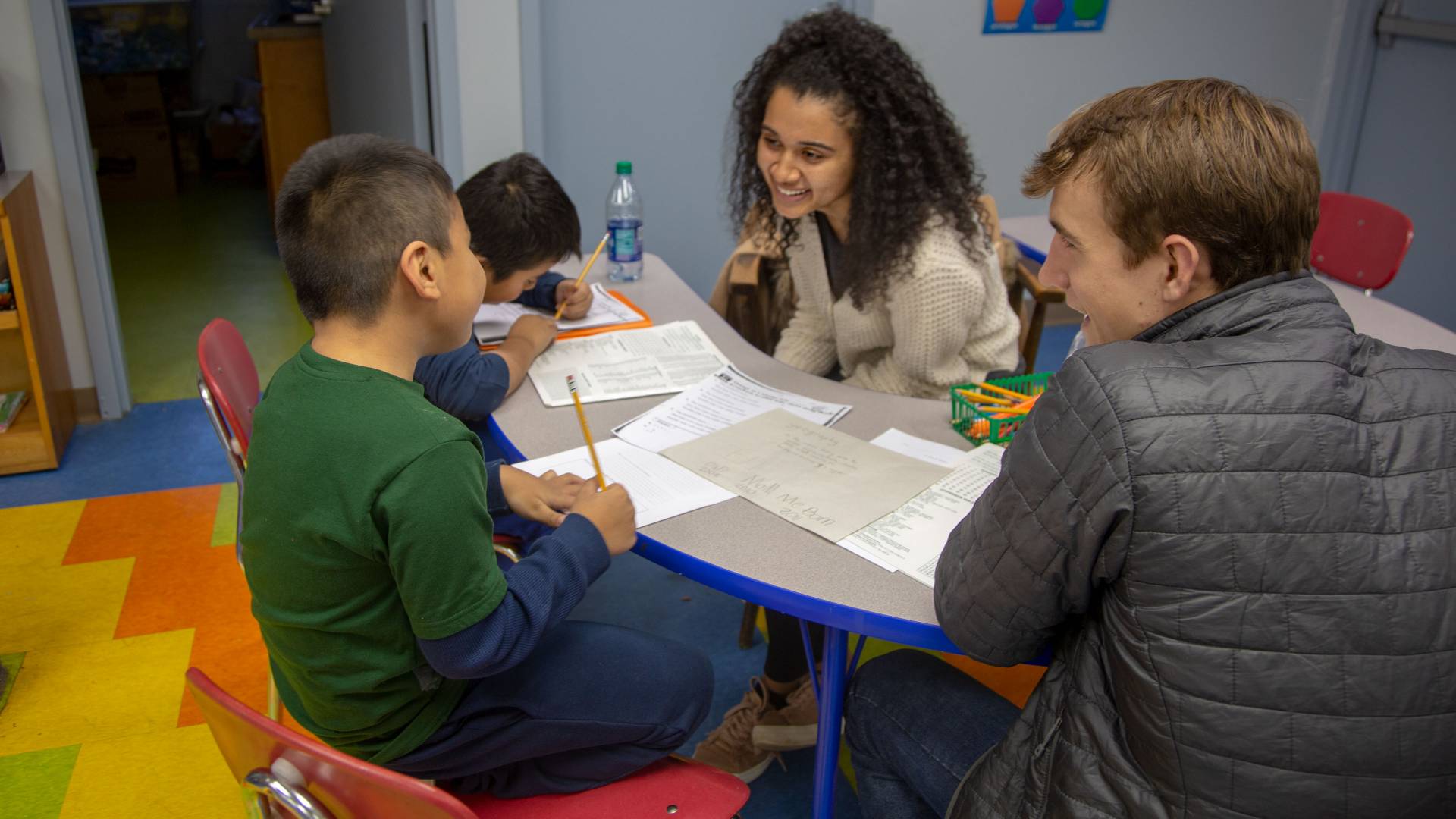 Students engaging with elementary school children