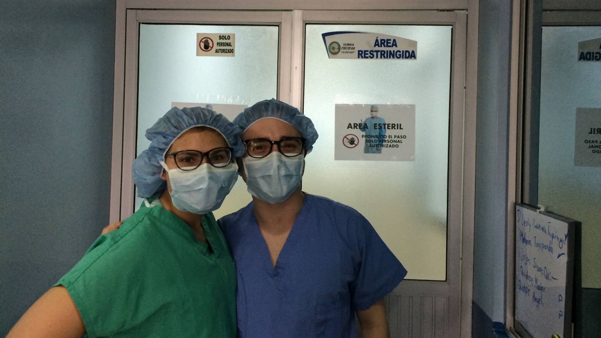 Two students in scrubs and face masks