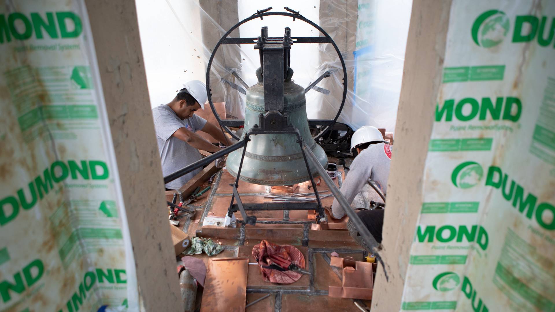 Workers working on bell in Nassau Hall cupola