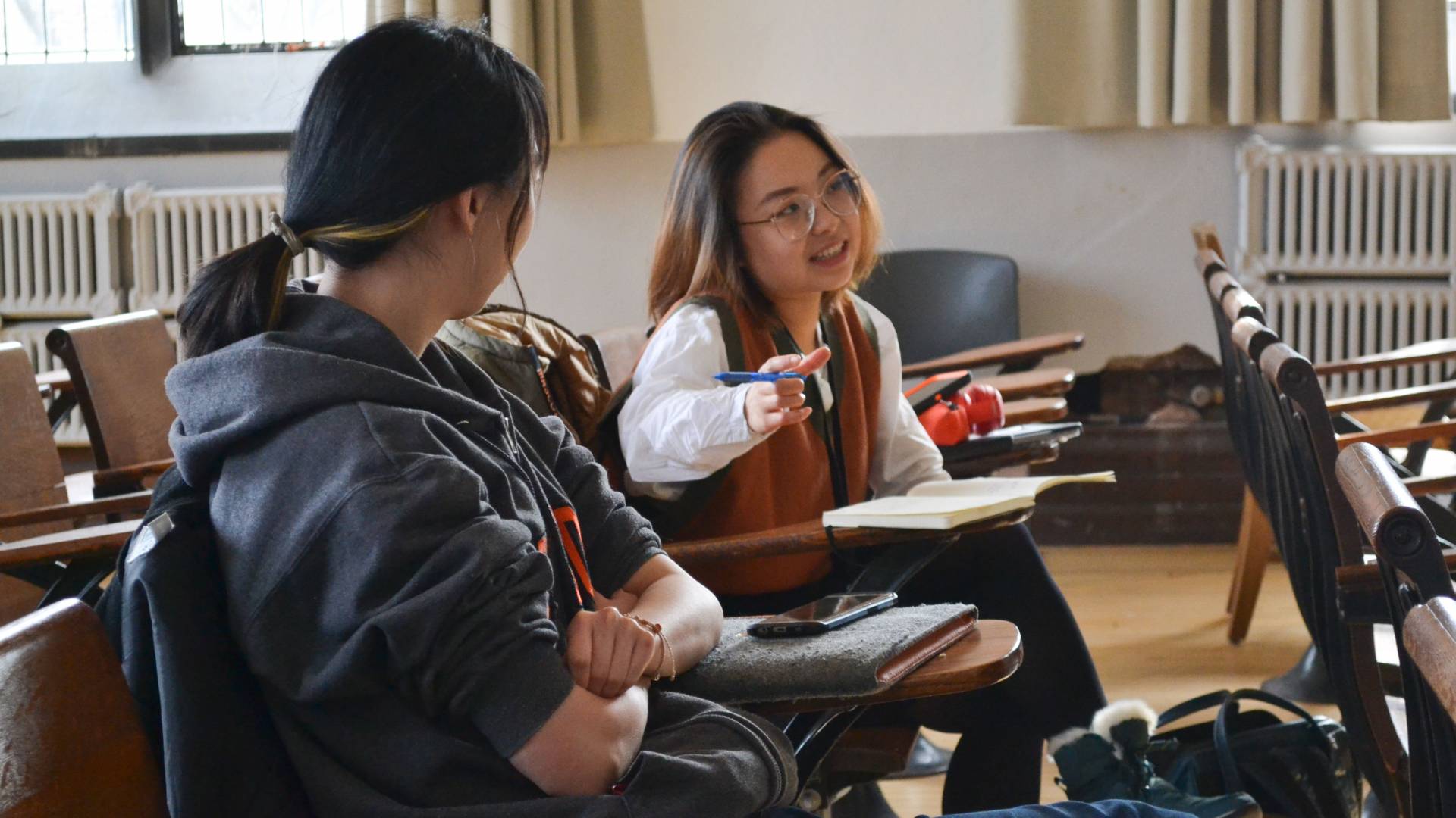 Student speaking in class while other student listens