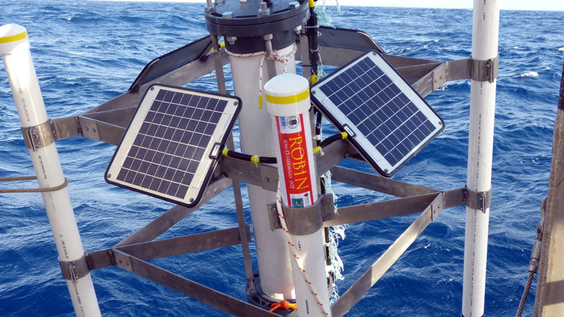 A Son-O-Mermaid instrument over the ocean on a crane