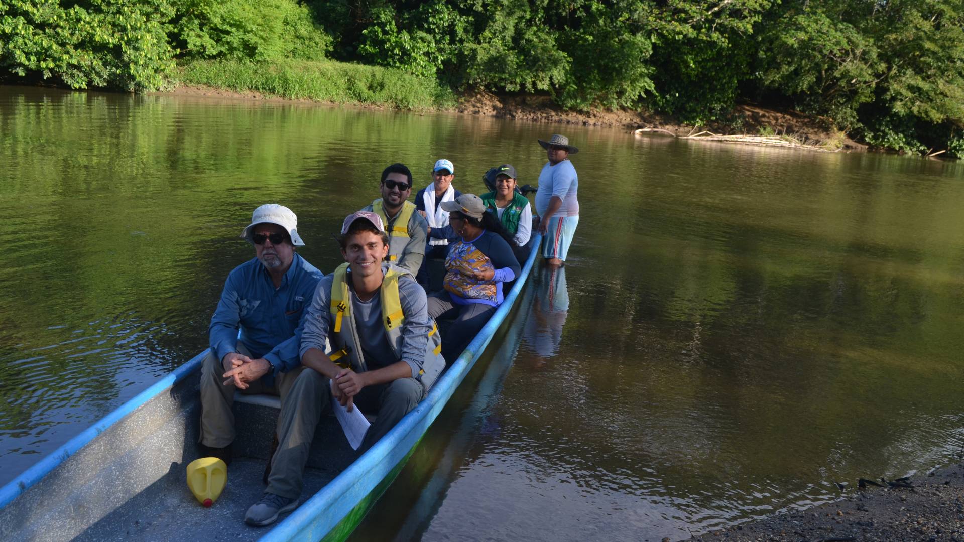 People sitting in long shallow boat