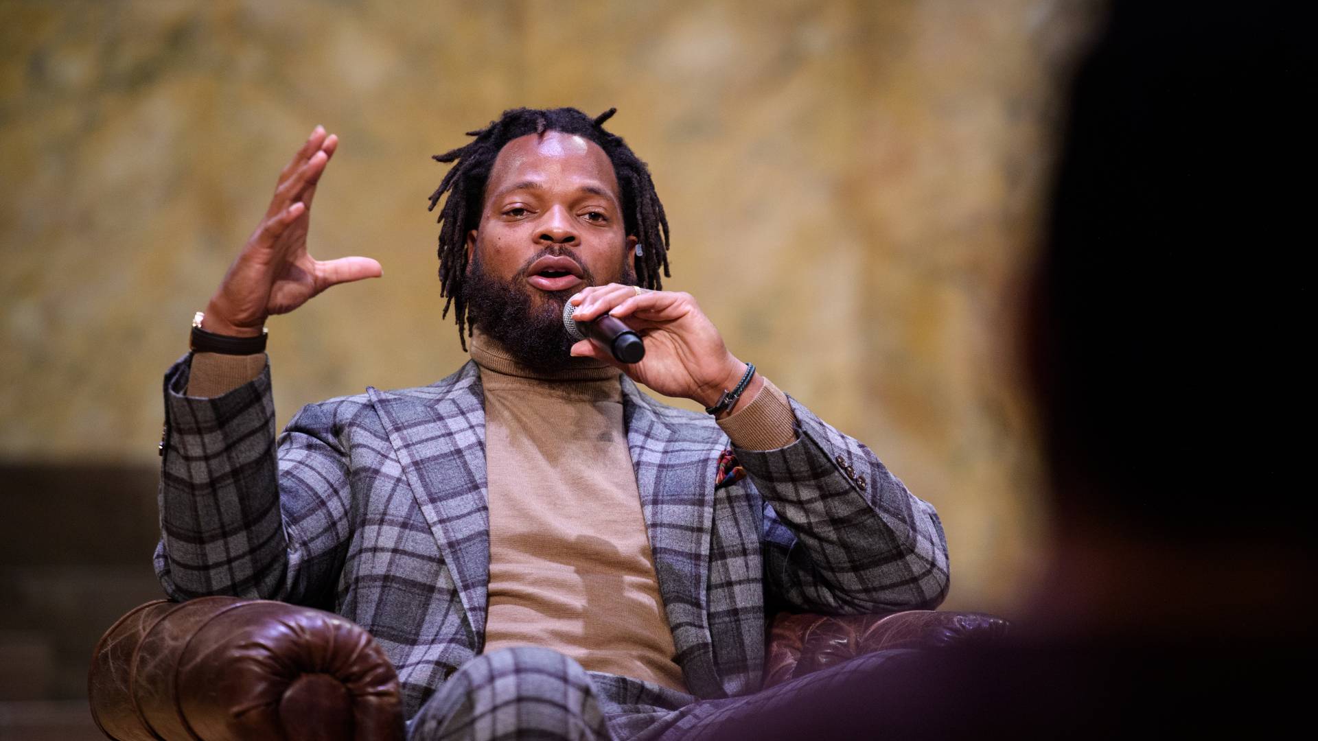 Michael Bennett speaks on stage