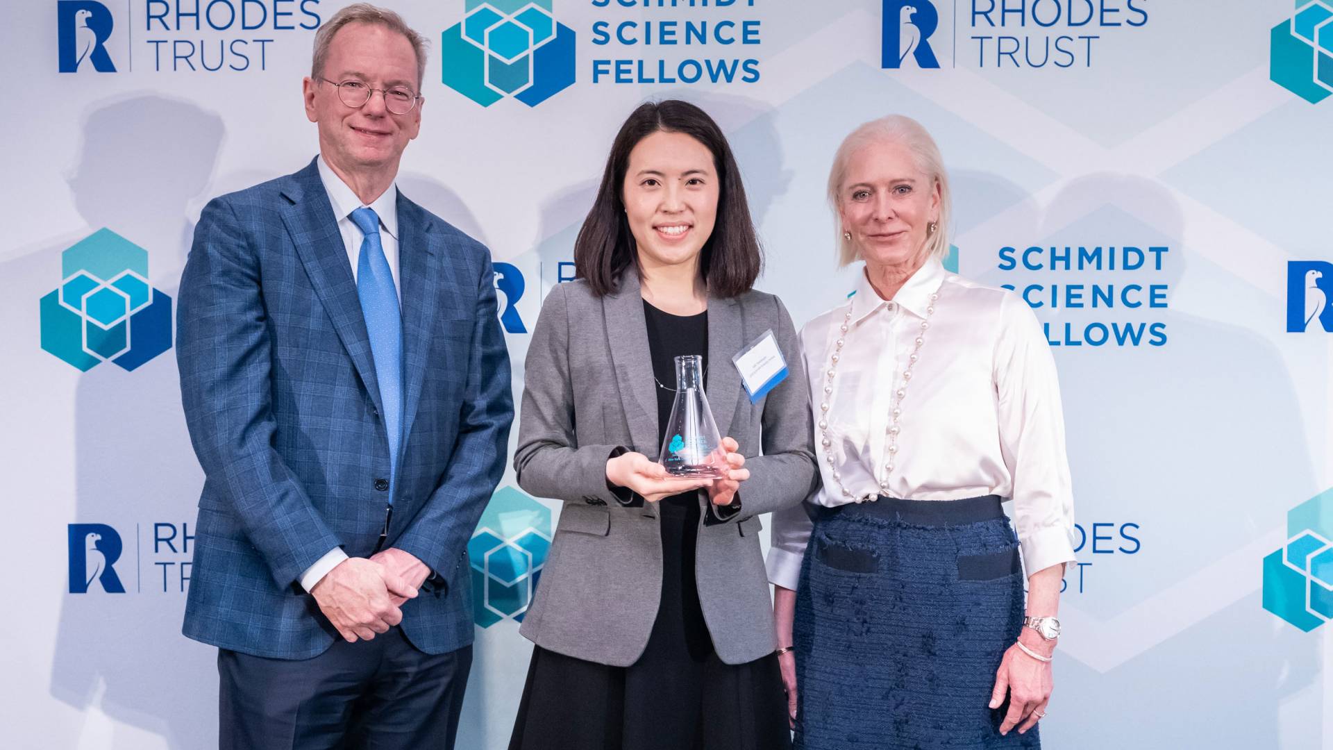 Eric and Wendy Schmidt standing with Saki Takahashi