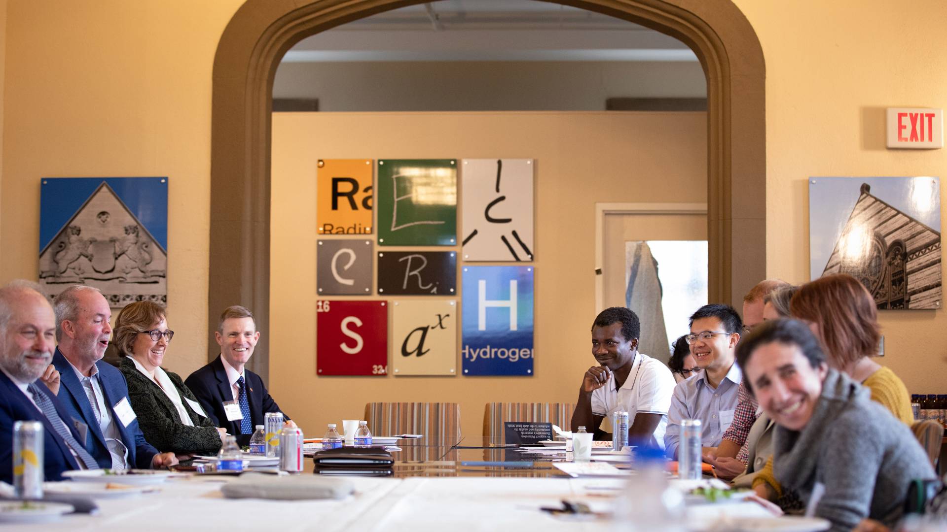 faculty members sit around a table to discuss issues