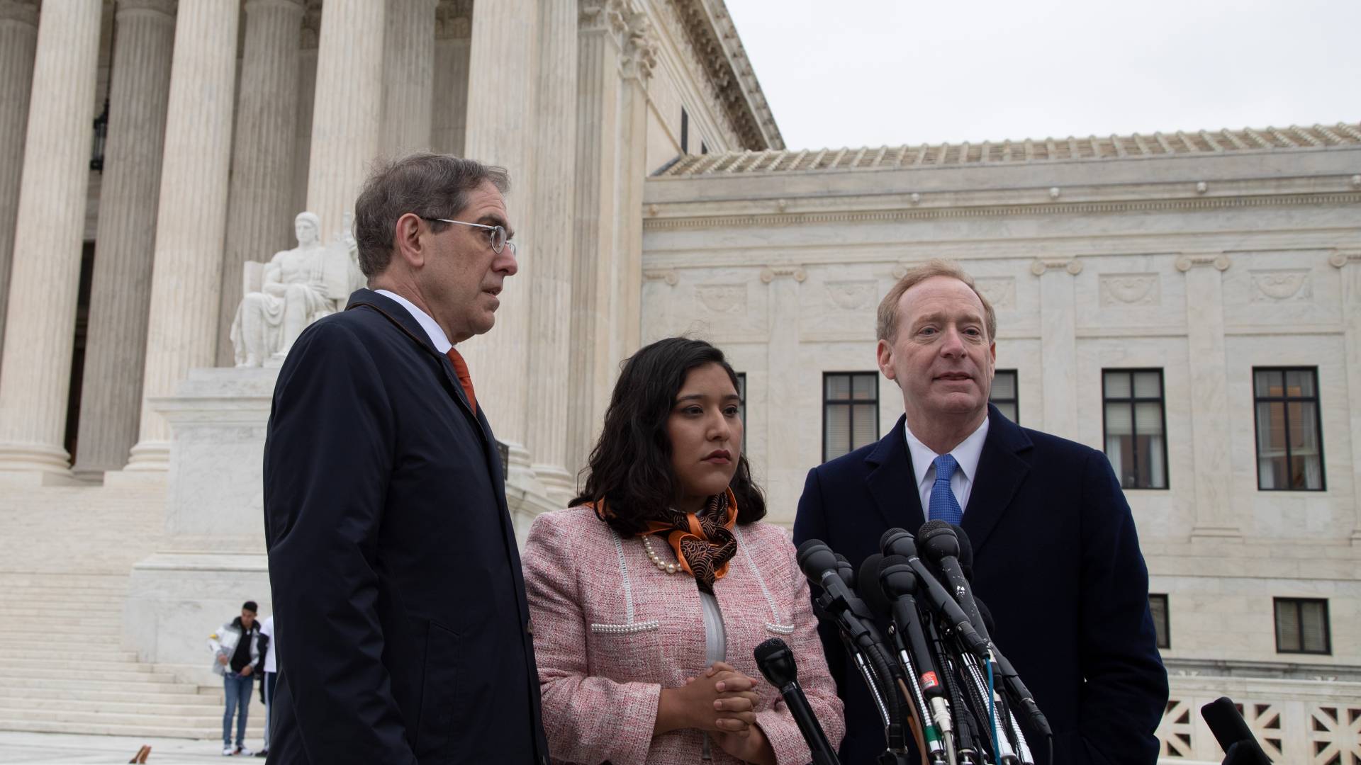 Christopher Eisgruber, Brad Smith and Maria Perales Sánchez on the steps of the Supreme Court building in Washington, D.C.
