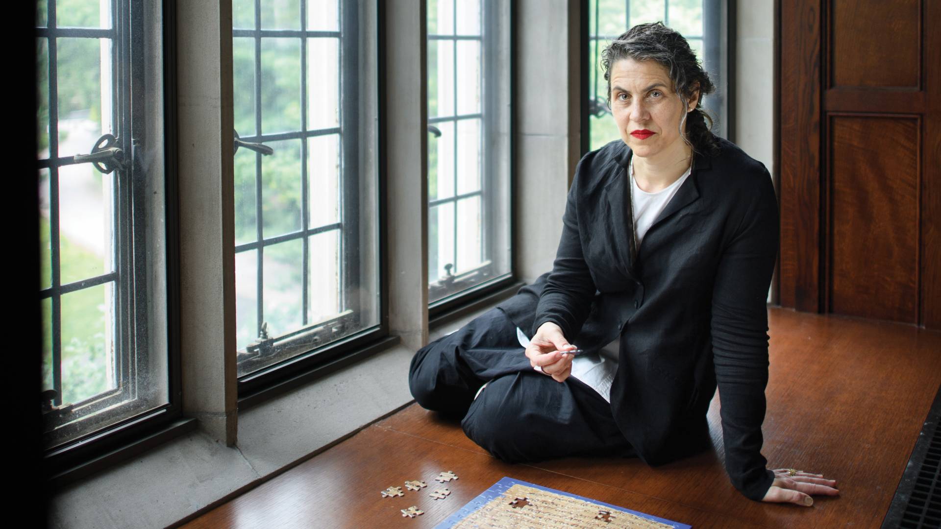 Marina Rustow in front of a jigsaw puzzle