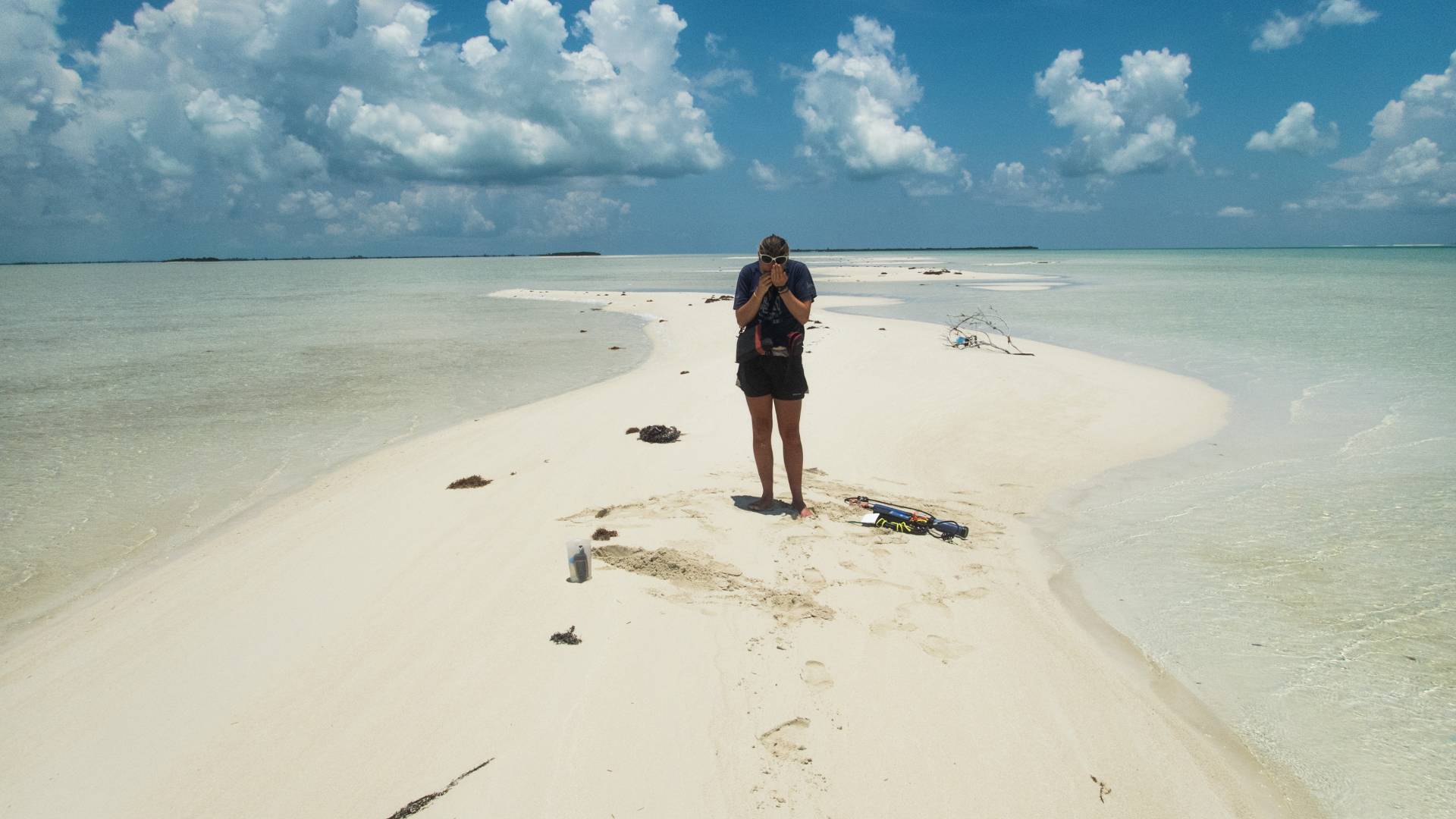 A student stands on a sand shoal