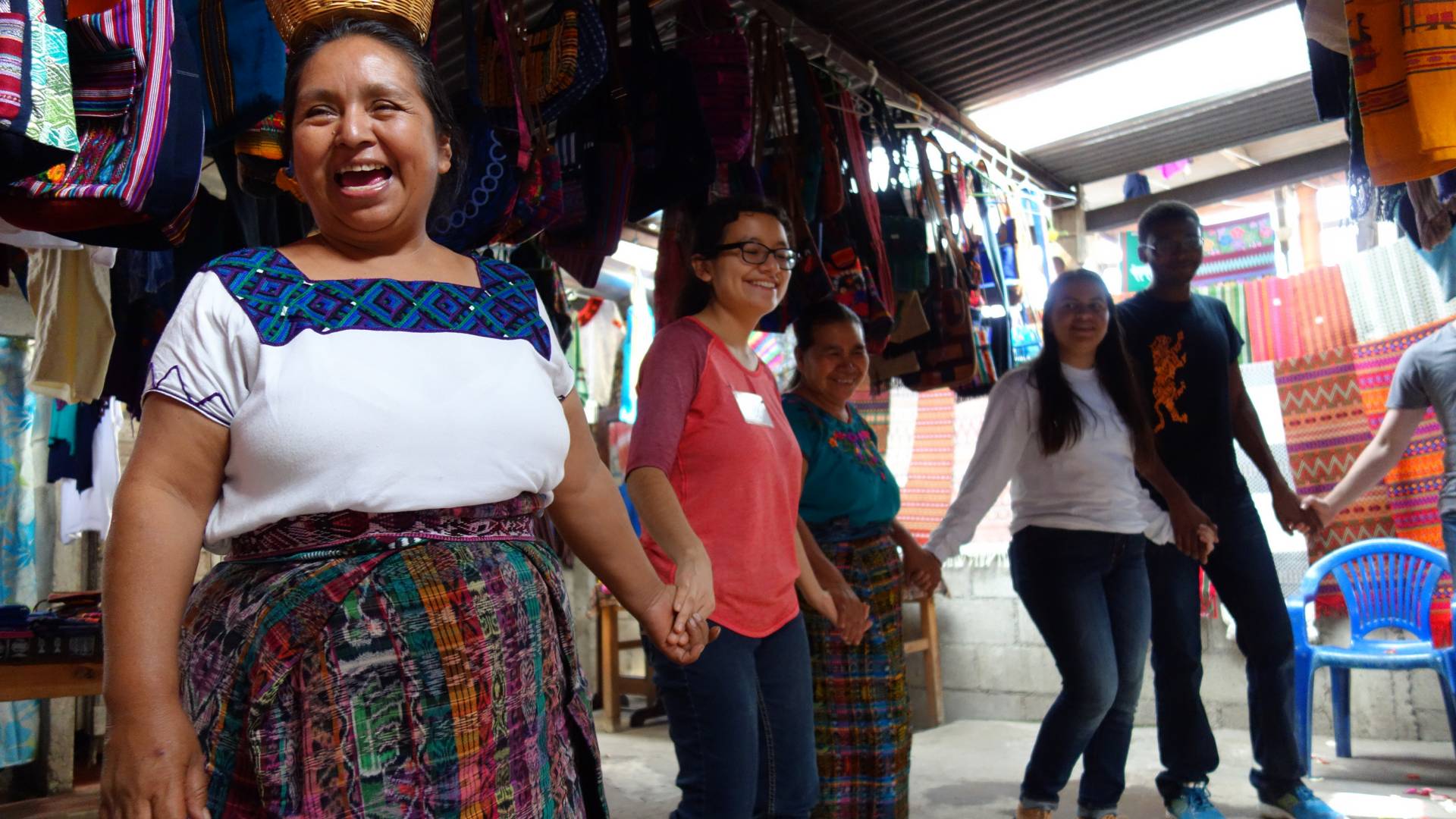 A Guatemalan woman leads a group of students in a dance