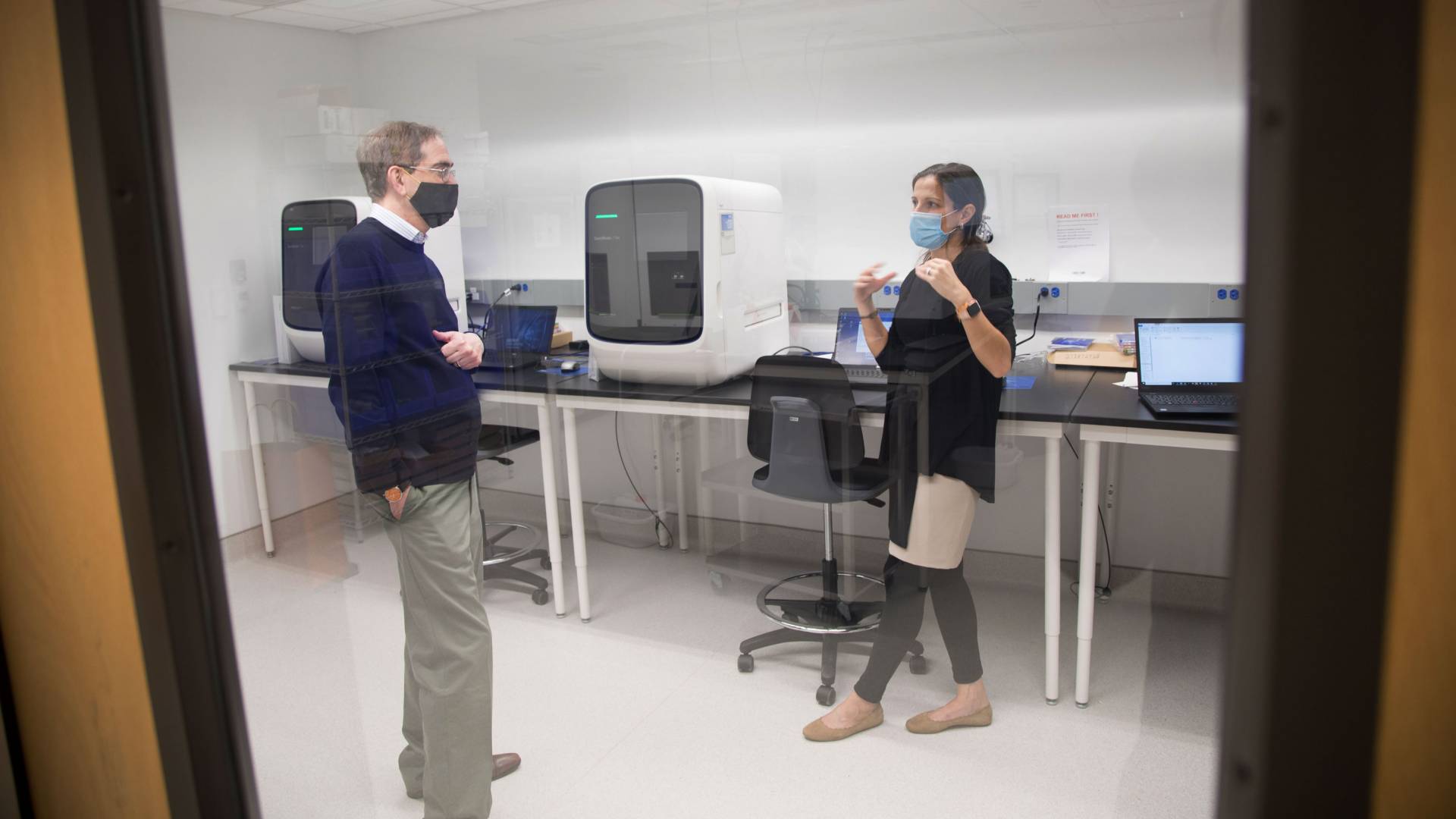 Christoper Eisgruber speaking to a staff member