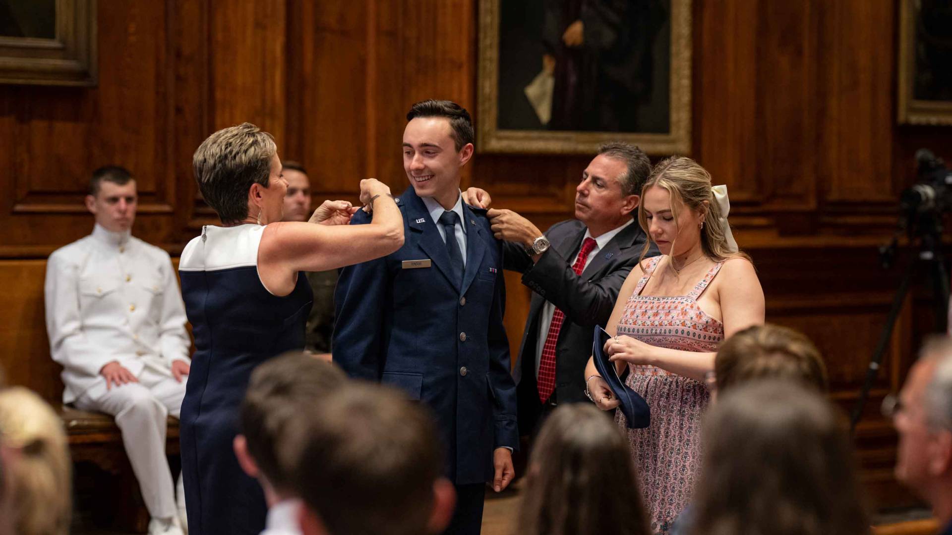 ROTC cadet receiving pins from family members
