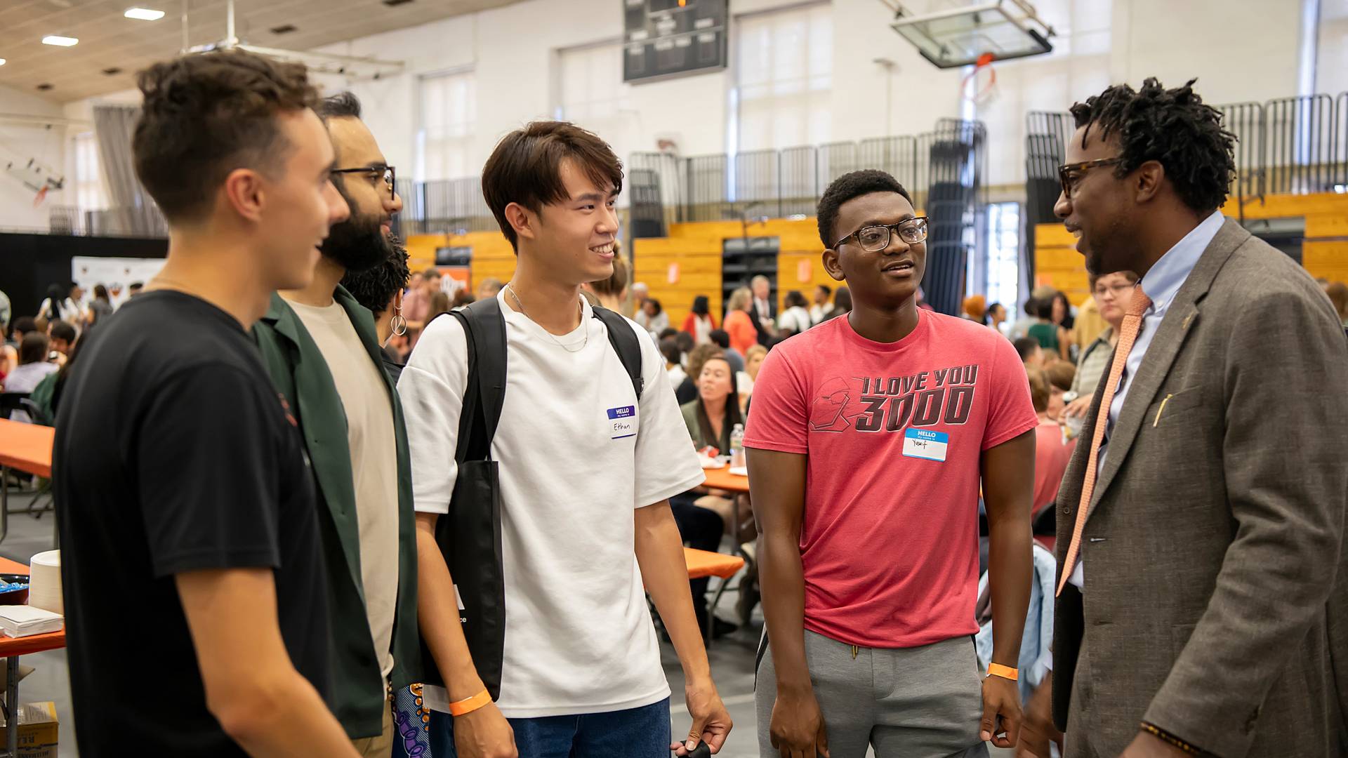 Students gathered in a line listening to Graduate School Dean Rodney Priestley