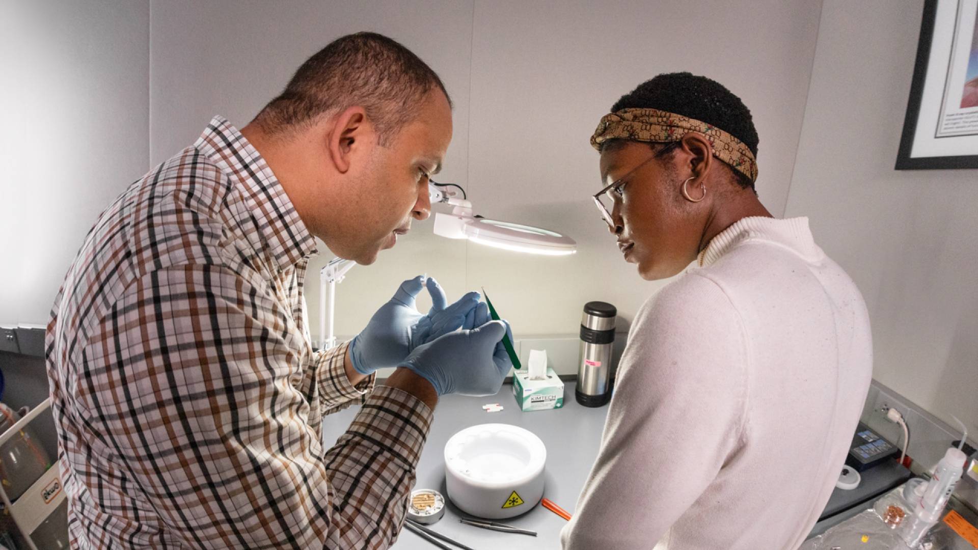 John Jimah and Jenny Nwokeji prepare a sample.