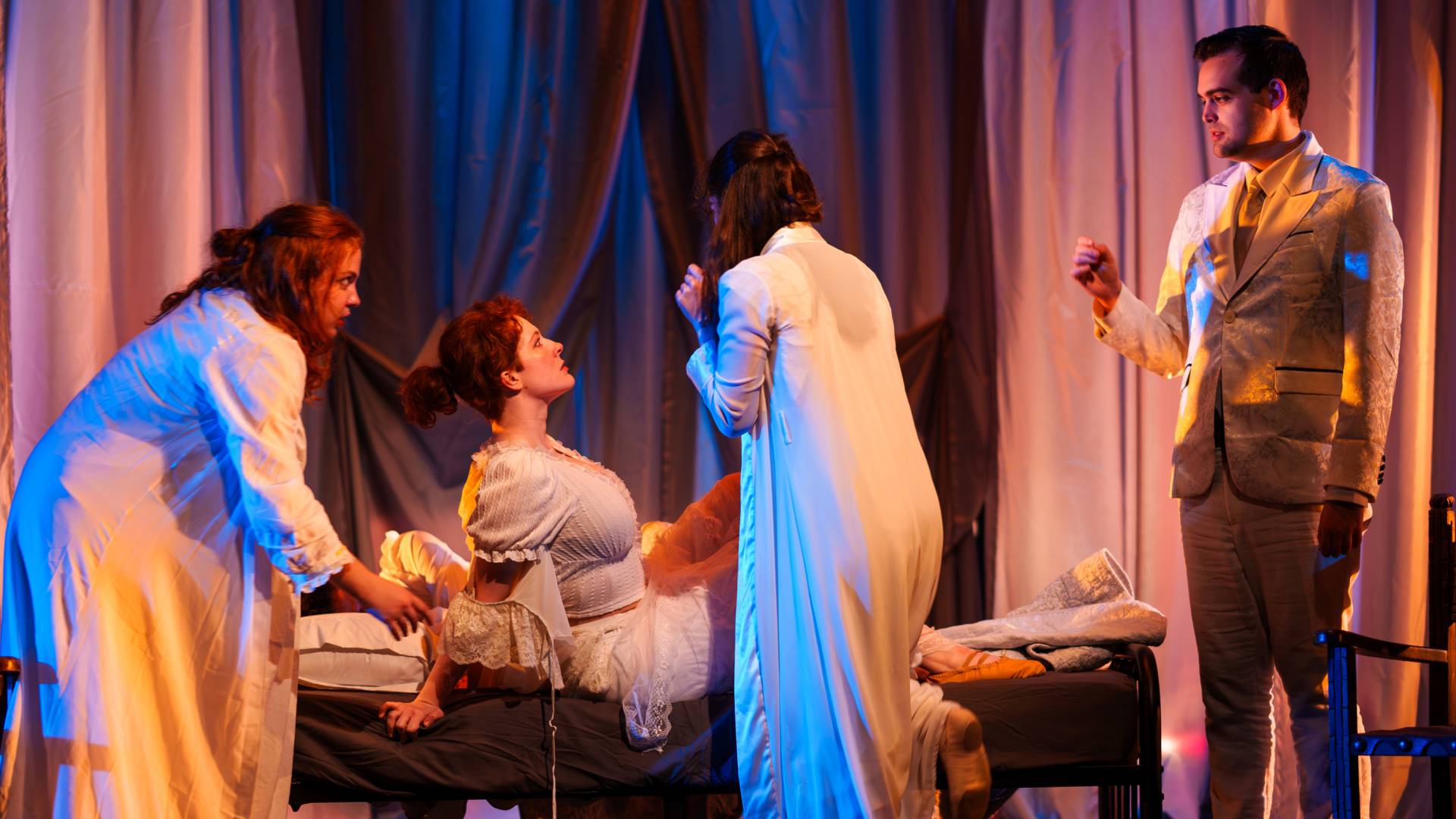 Actors surround a bed in a scene from "Dracula"