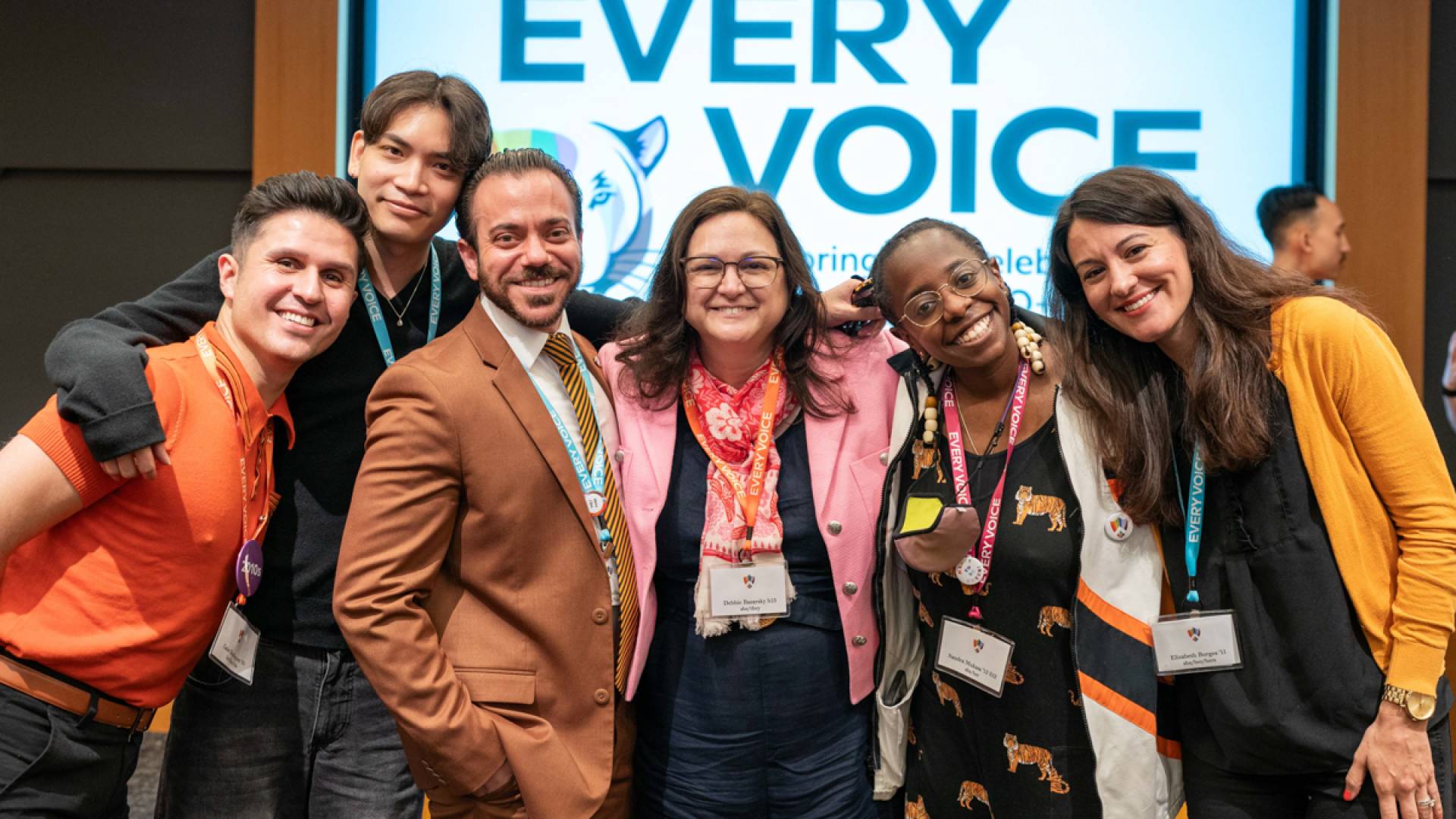 Group of people smiling standing shoulder to shoulder