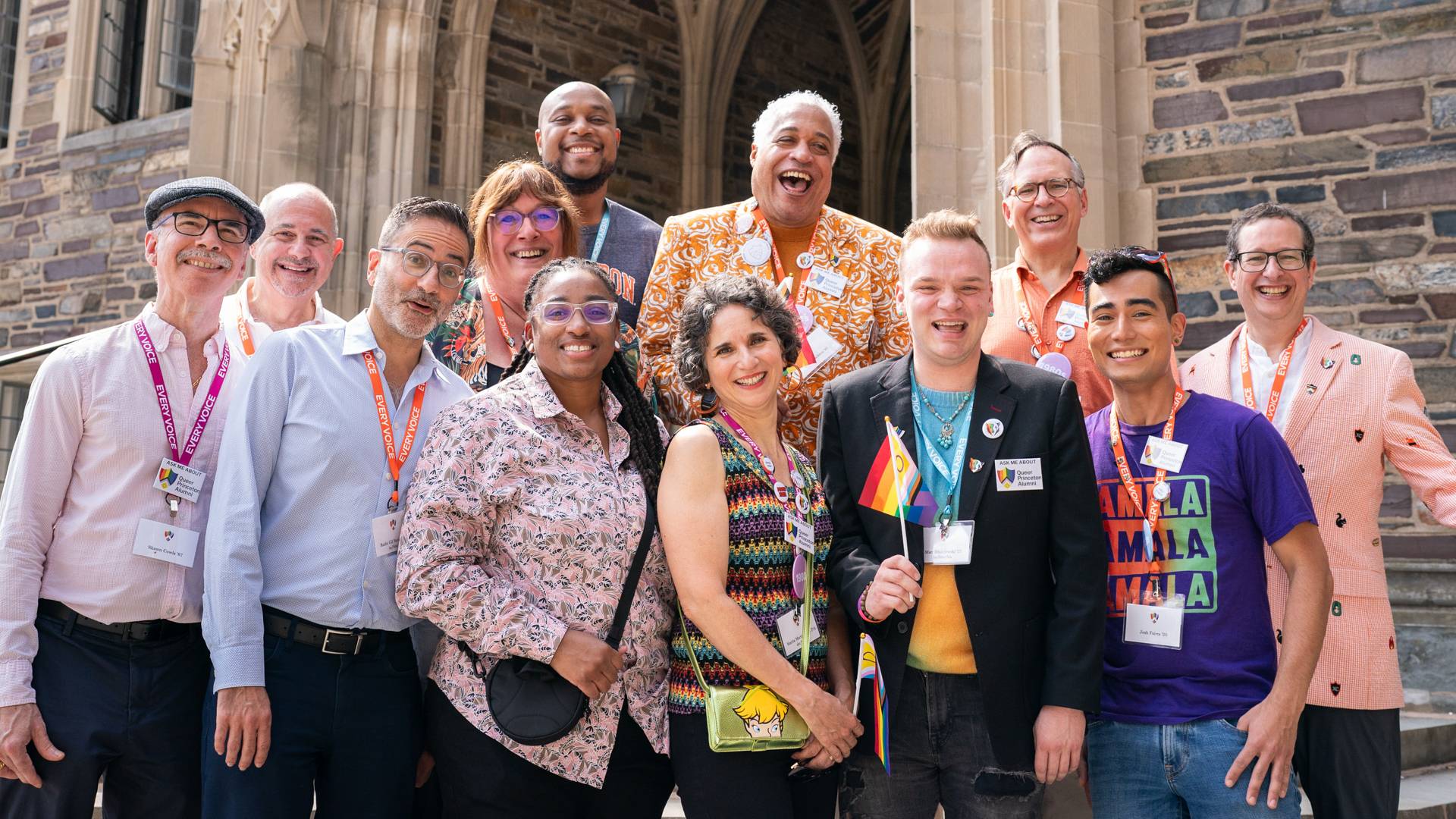 Several people standing shoulder to shoulder looking at the camera smiling
