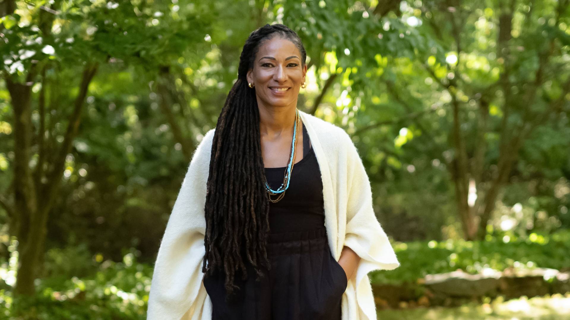 Ruha Benjamin in front of campus greenery