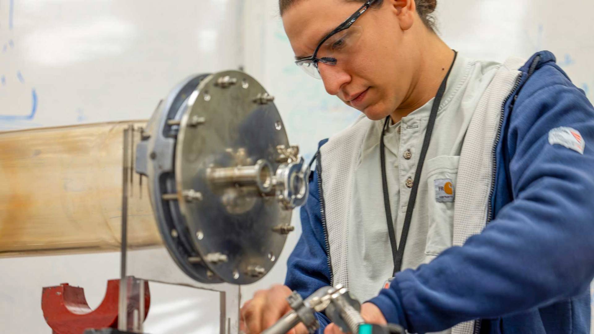 An apprentice works on some machinery