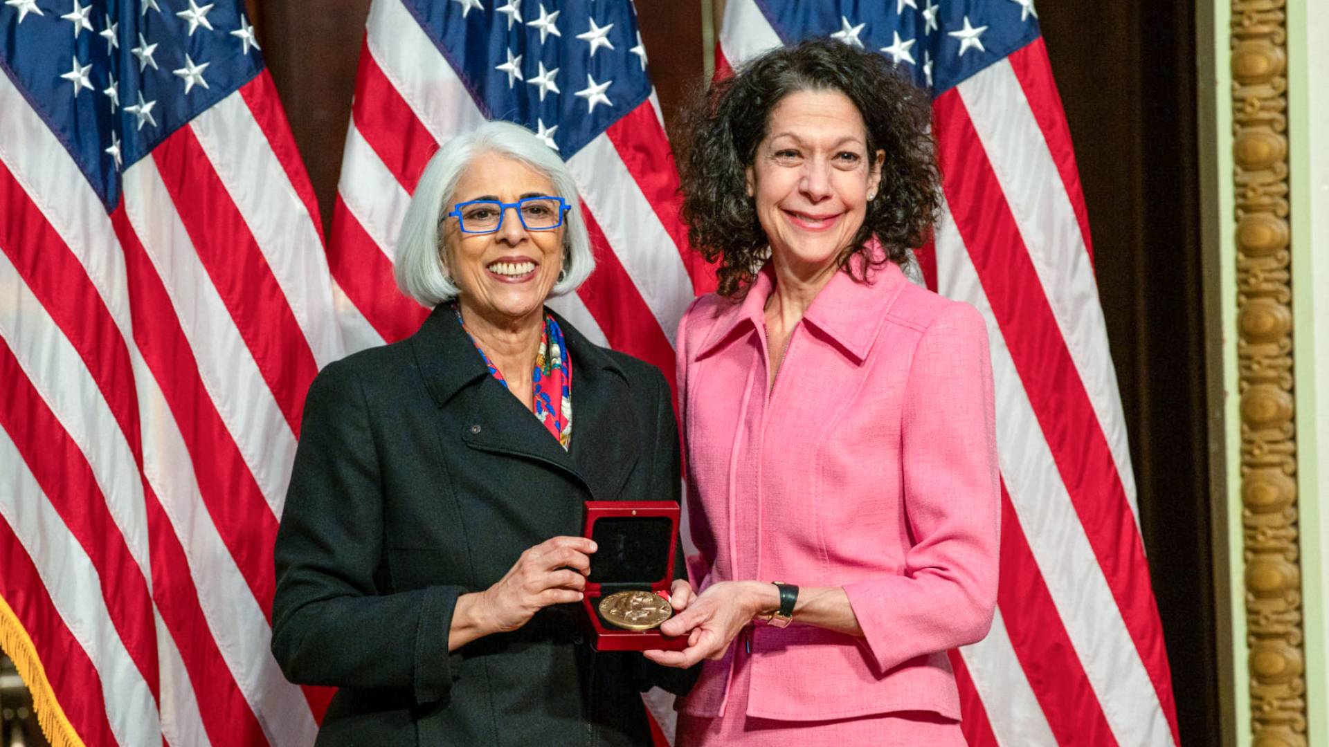 Bonnie Bassler smiles with a White House official.
