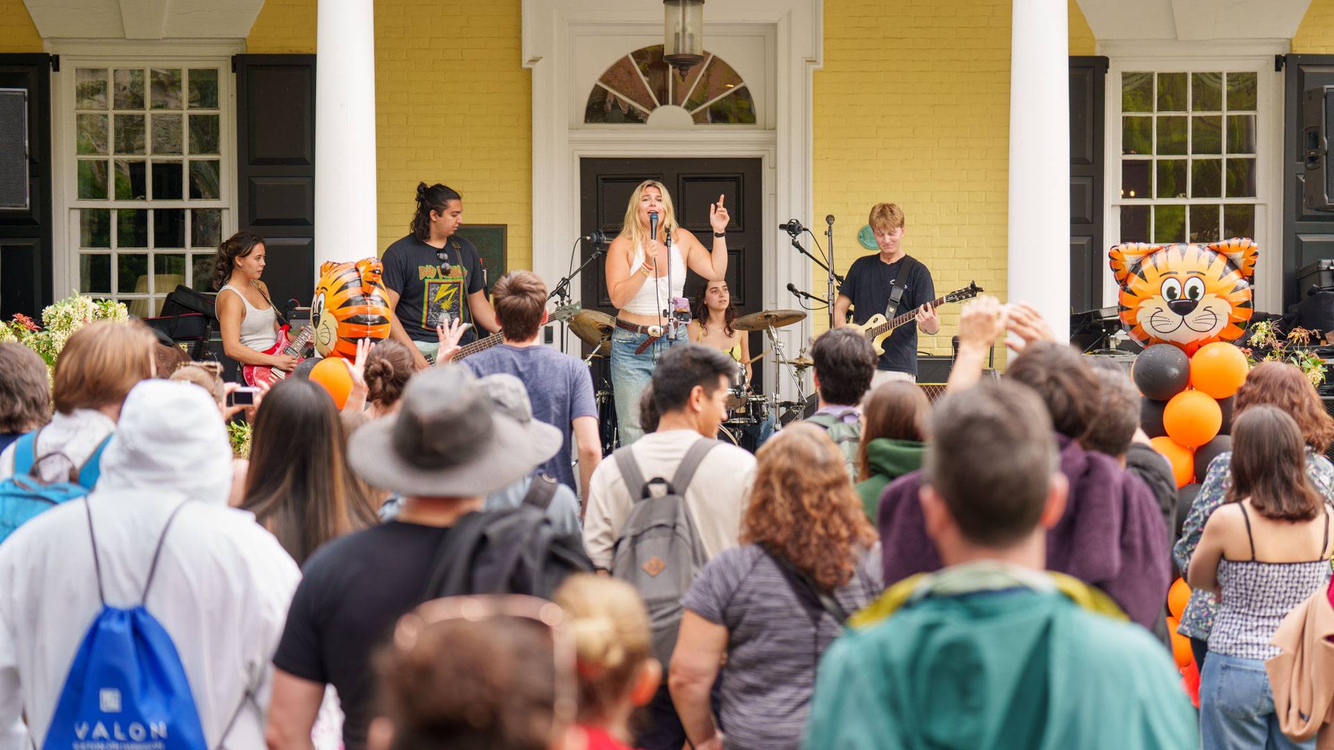 A band performs from a porch