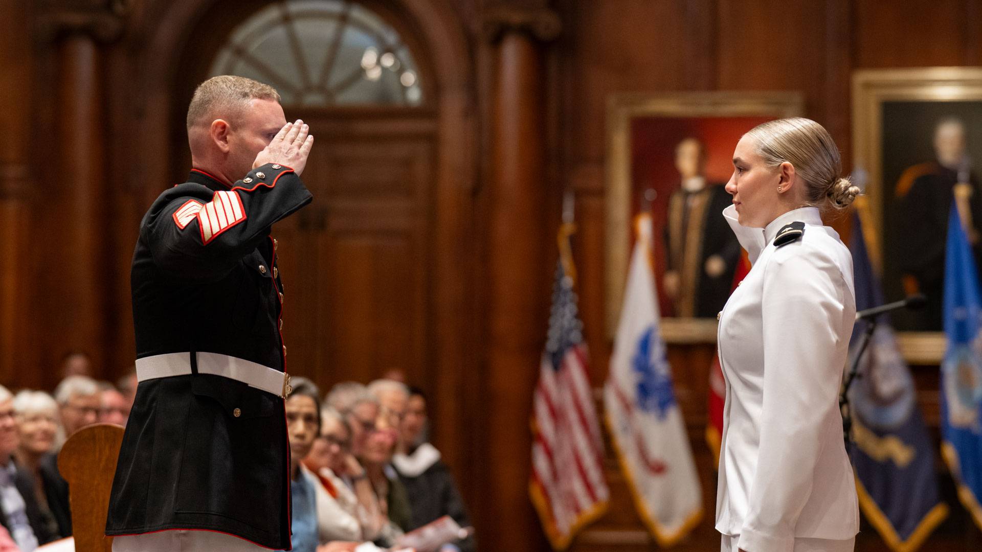 A new officer performs her Silver Dollar Salute with a decorated master sergeant.