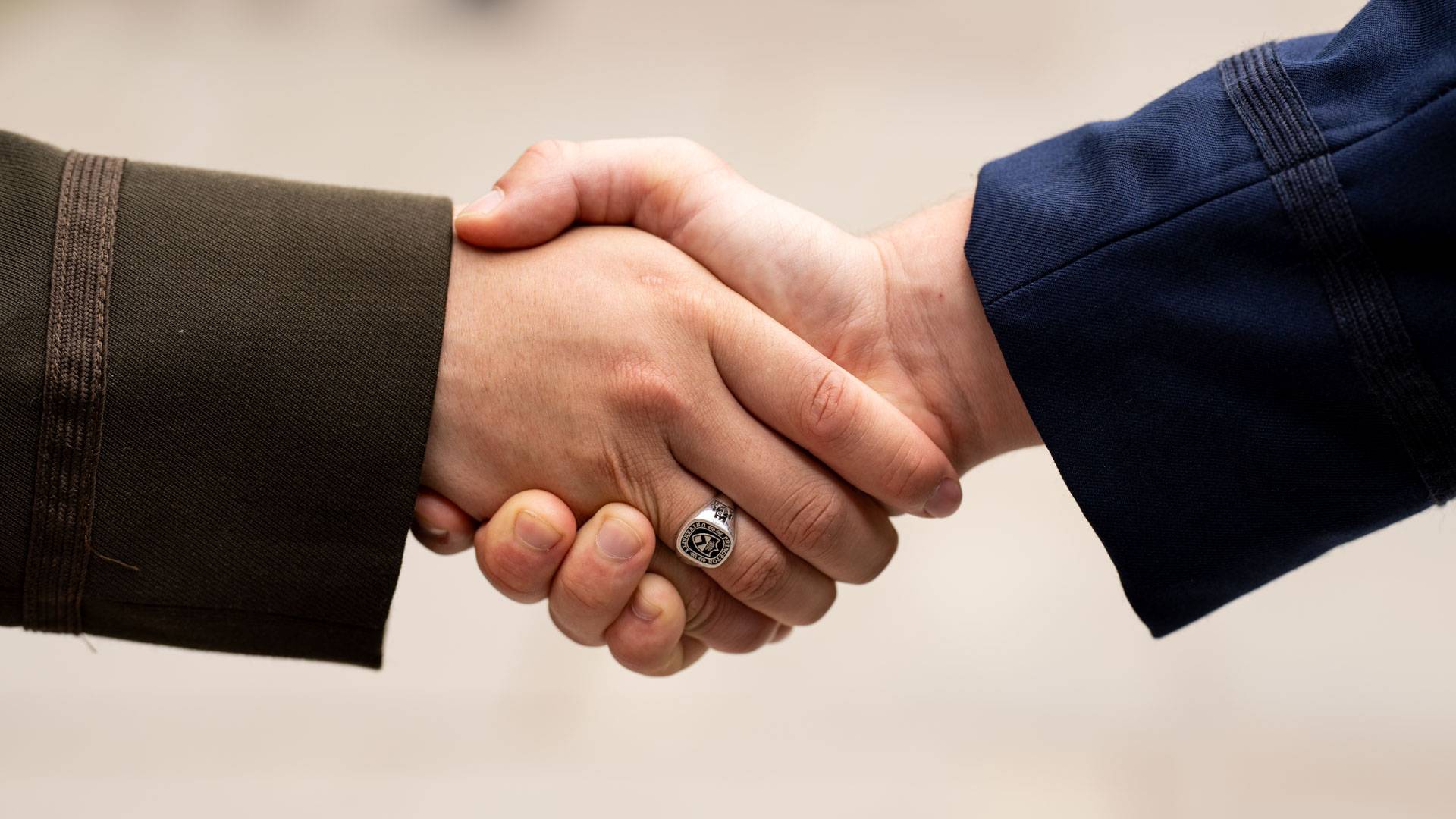 Closeup of a handshake at the Commissioning ceremony
