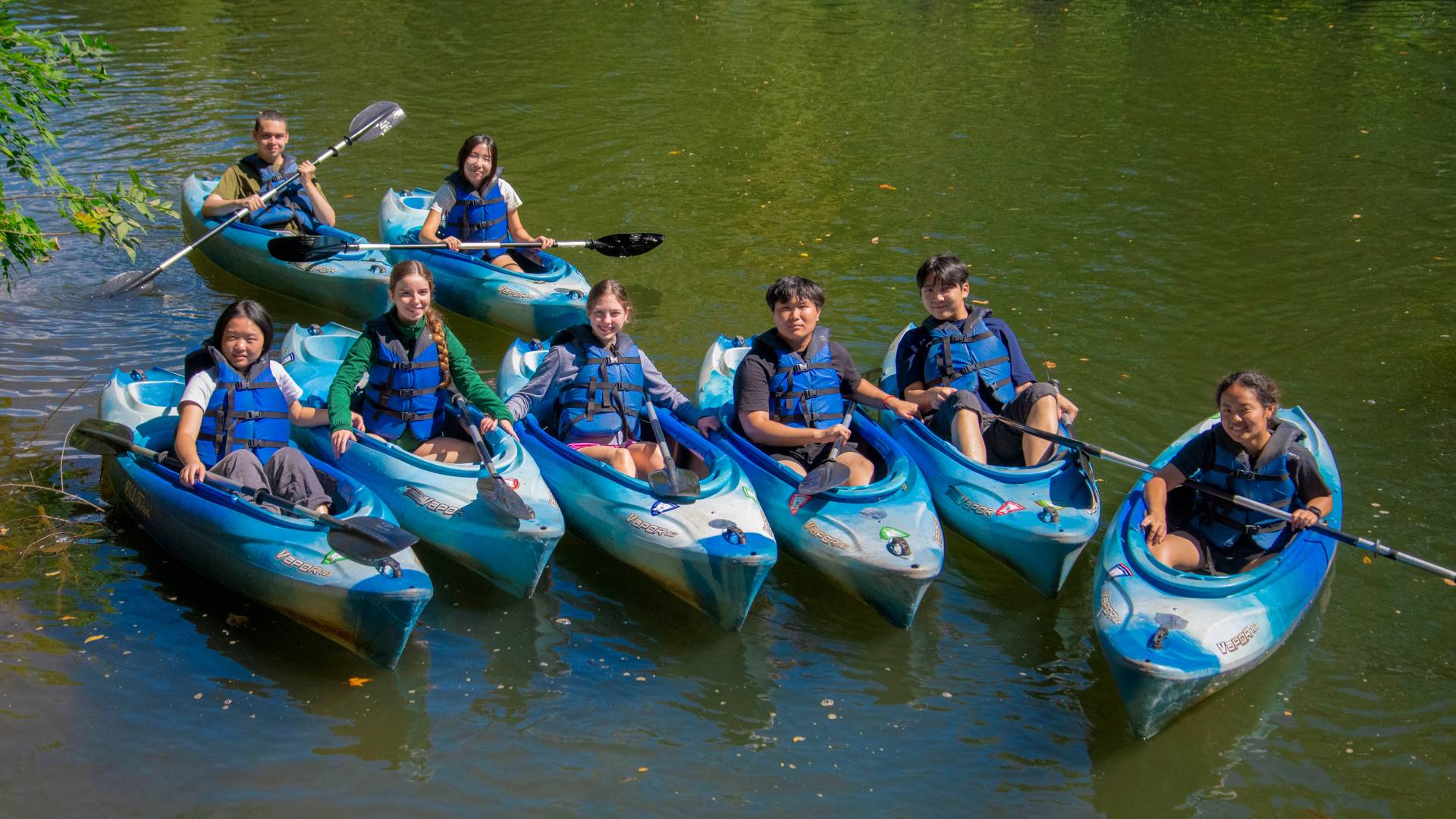Students in kayaks on a lake