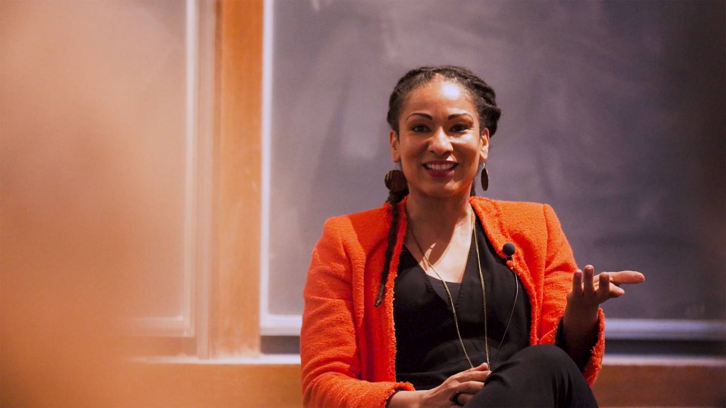 Ruha Benjamin speaks in front of a group