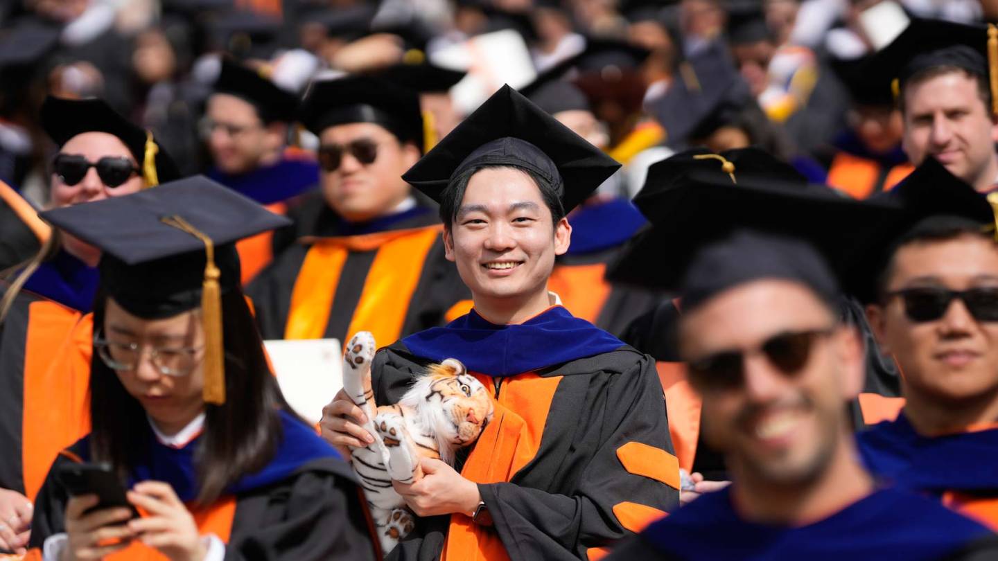 A student in cap and gown at Commencement