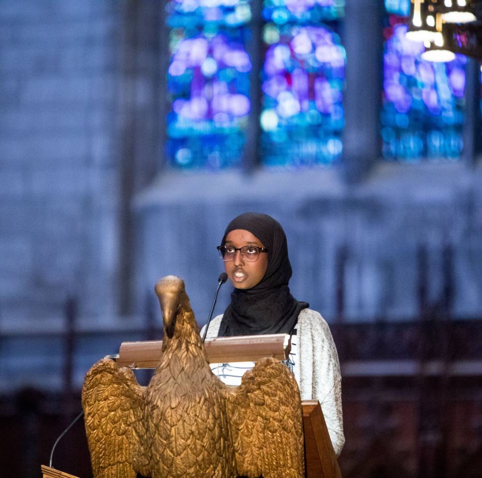 Sirad Hassan reading from the Quran at podium