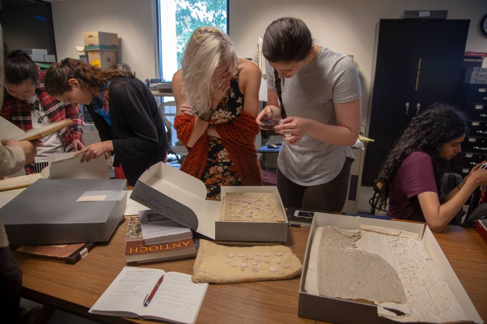 Students looking at ancient artifacts at Art Museum