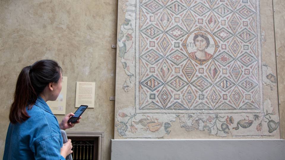 Student looking at large mosaic on wall at Worcester Art Museum