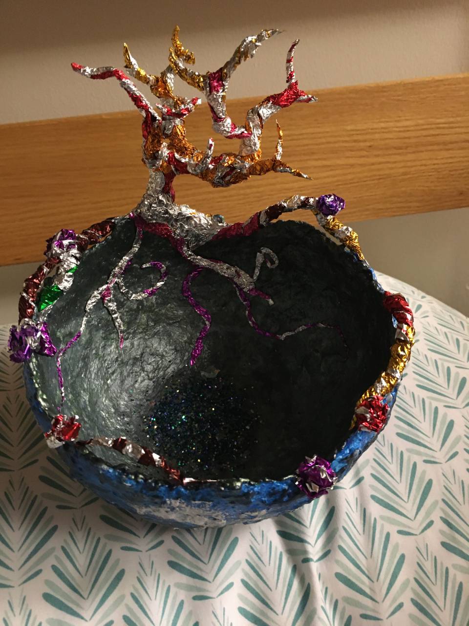 Dark handmade bowl with a decorative tree form
