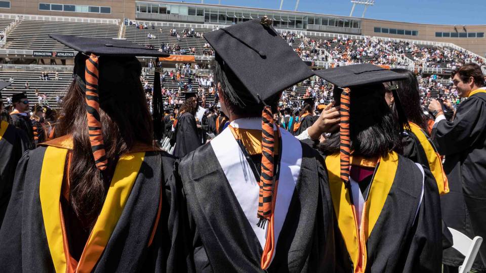 Graduating students with tiger tails in their hats