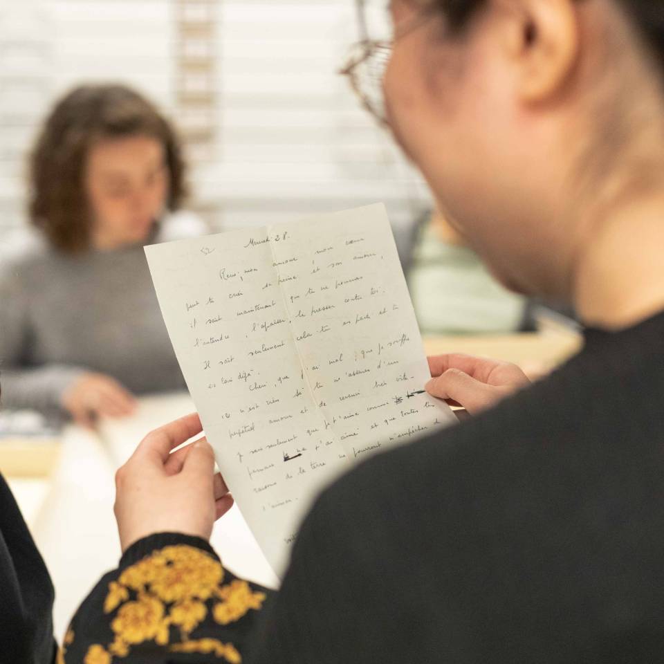 A student holding old documents.
