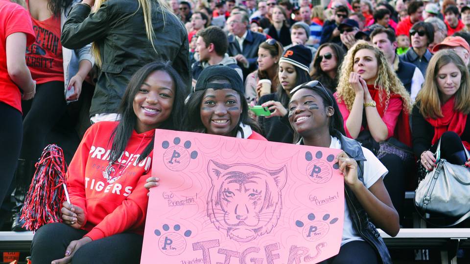 Princeton football fans holding a sign in the stadium