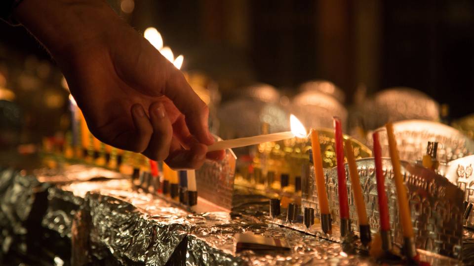 Student lighting a menorah for Chanukah