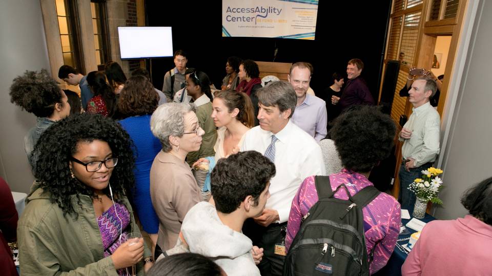 Students, faculty, and staff gather for the opening reception