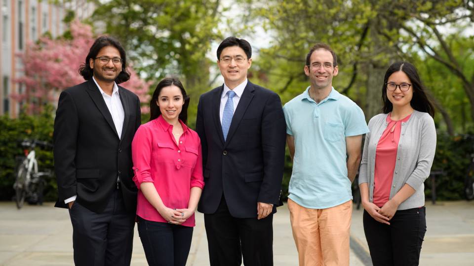 Researchers stand together outdoors