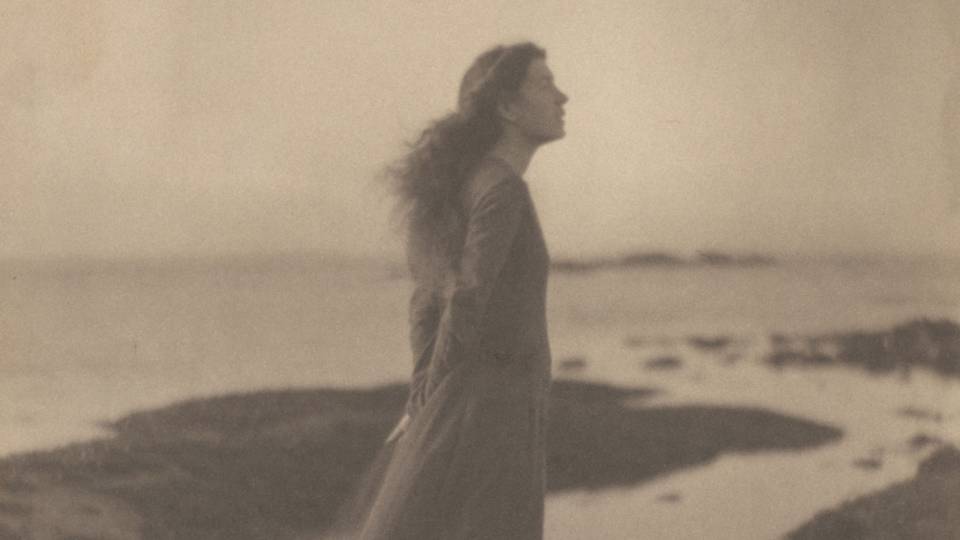 Woman standing by the sea